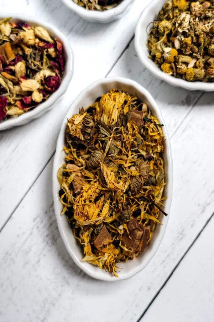 White dishes of loose herbal blends with golden petals