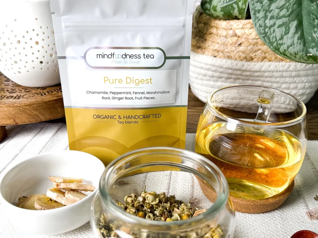 Pure Digest Tea pouch with a glass cup and a jar of chamomile